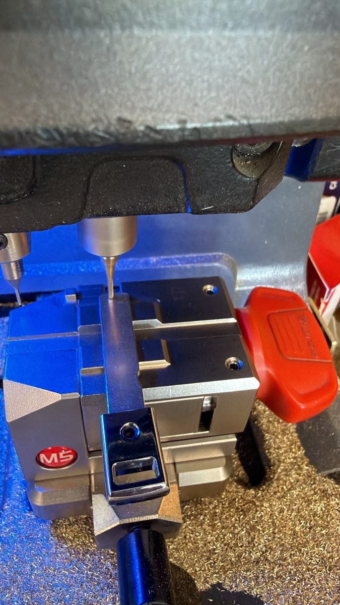 Locksmith cutting a replacement car key in Jacksonville, FL