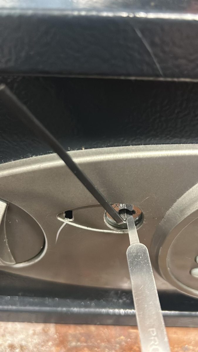 Locksmith working on a locked safe during a service call