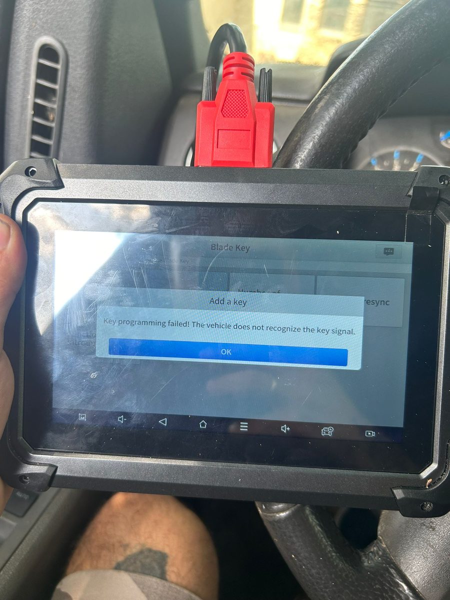 Automotive locksmith programming a new car key in Jacksonville, FL