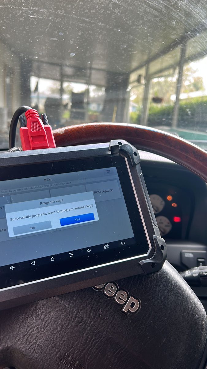 Locksmith programming a car key fob