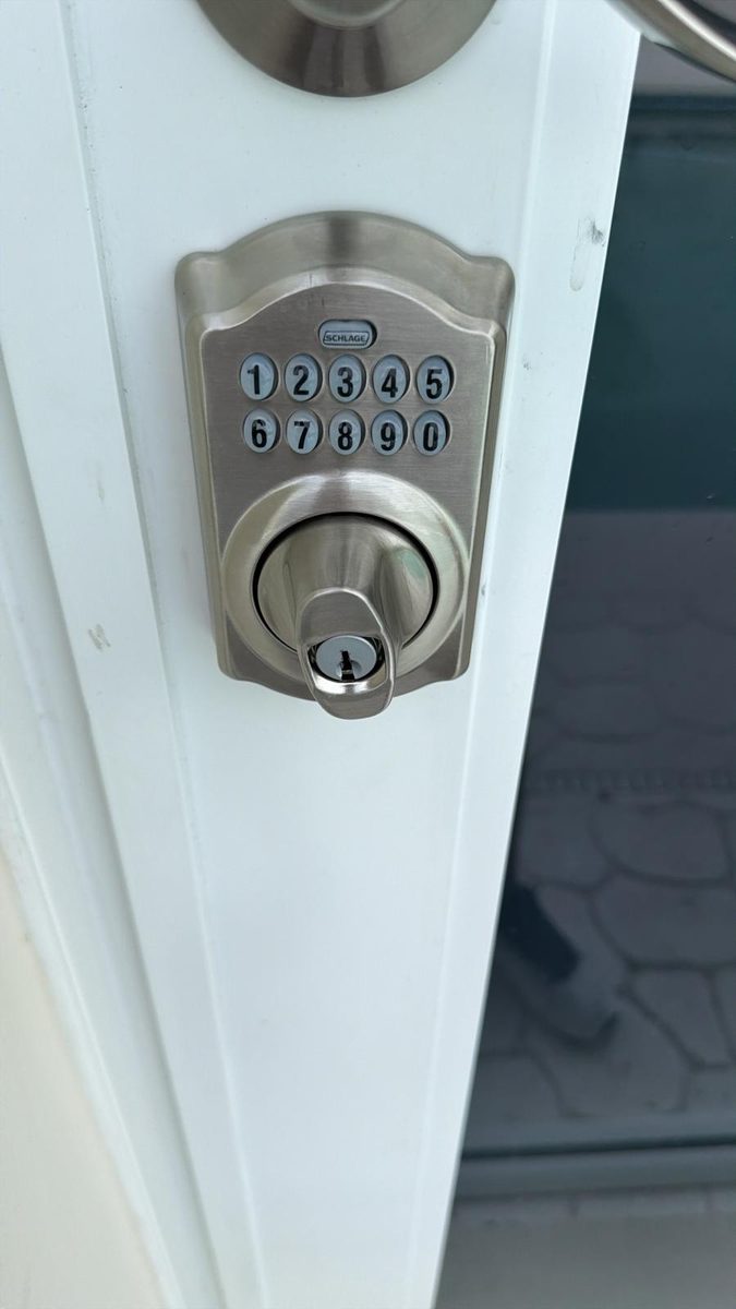 Locksmith installing a new deadbolt on a residential door in Jacksonville