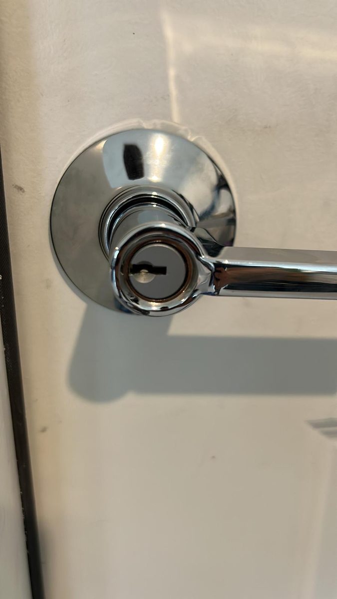 Locksmith changing a door handle lock at a Jacksonville home